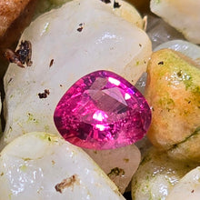 Load image into Gallery viewer, A picture of a single pink spinel gemstone with a pear shape, set in a white matrix, with small inclusions.
